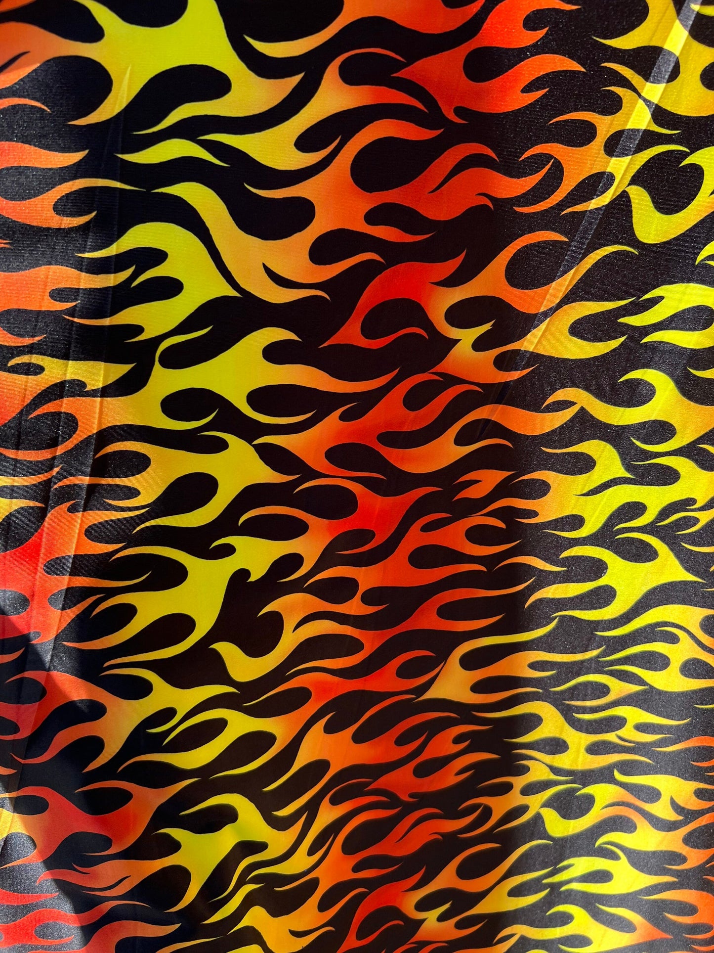 New Flame design Black/Fire color print on light weight poly spandex 2-way stretch 58/60” Sold by the Yd.