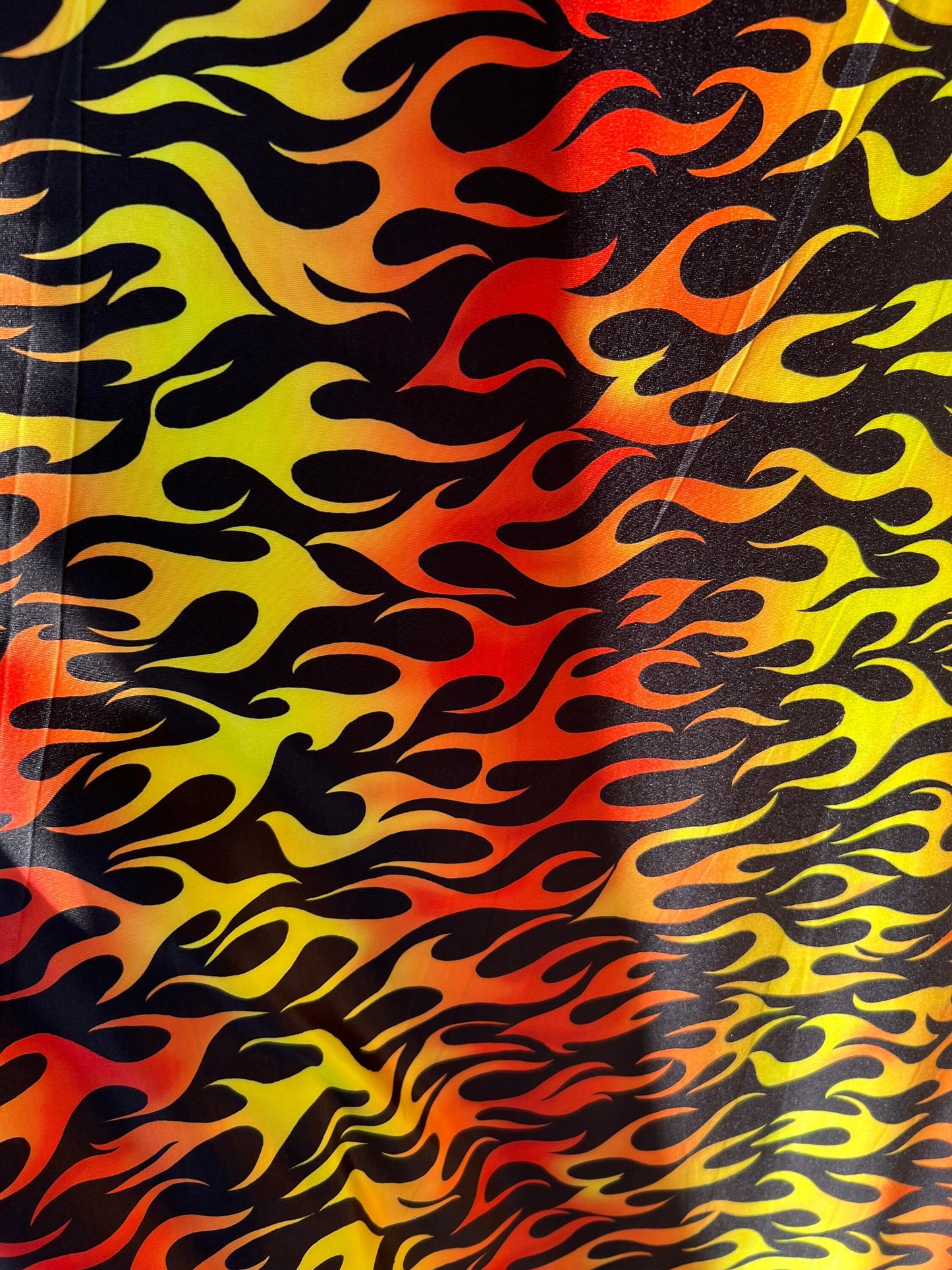 New Flame design Black/Fire color print on light weight poly spandex 2-way stretch 58/60” Sold by the Yd.