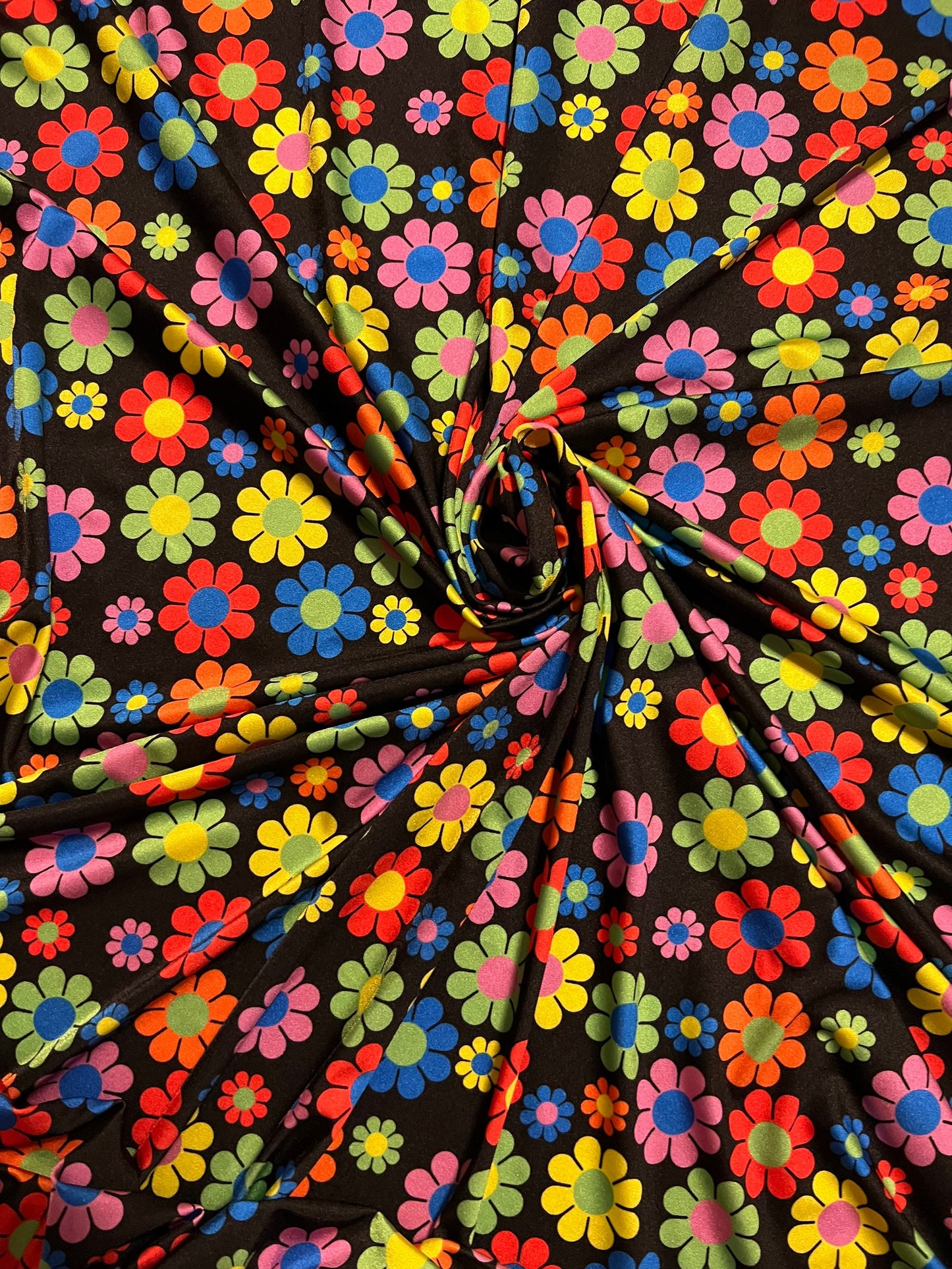 New daisy flower design Black/Multicolor print on great quality of nylon spandex 4-way stretch 58/60” Sold by the YD.