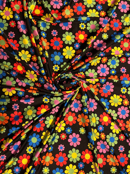 New daisy flower design Black/Multicolor print on great quality of nylon spandex 4-way stretch 58/60” Sold by the YD.