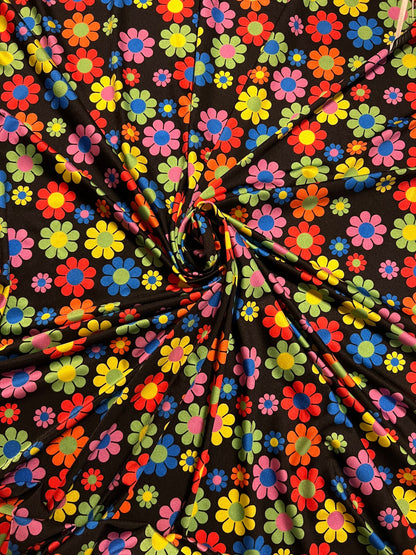 New daisy flower design Black/Multicolor print on great quality of nylon spandex 4-way stretch 58/60” Sold by the YD.