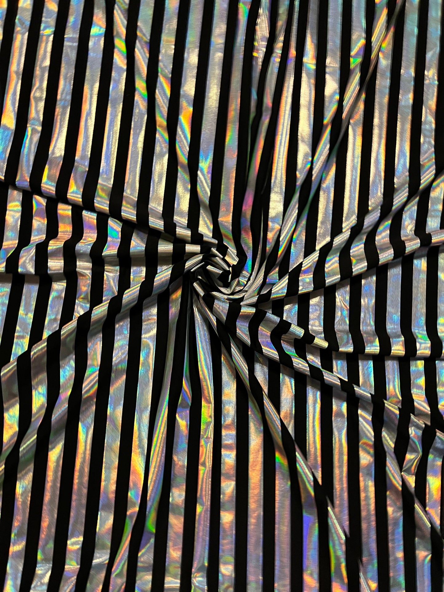 Metallic stripe design black/iridescent silver poly spandex 2-way stretch with lacer foil 58/60” Sold by the YD. Ships Worldwide from L.A CA