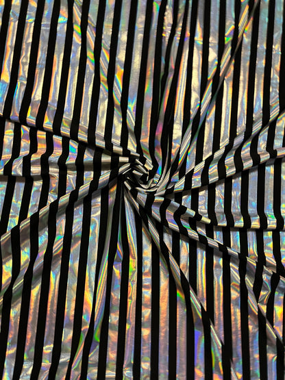 Metallic stripe design black/iridescent silver poly spandex 2-way stretch with lacer foil 58/60” Sold by the YD. Ships Worldwide from L.A CA