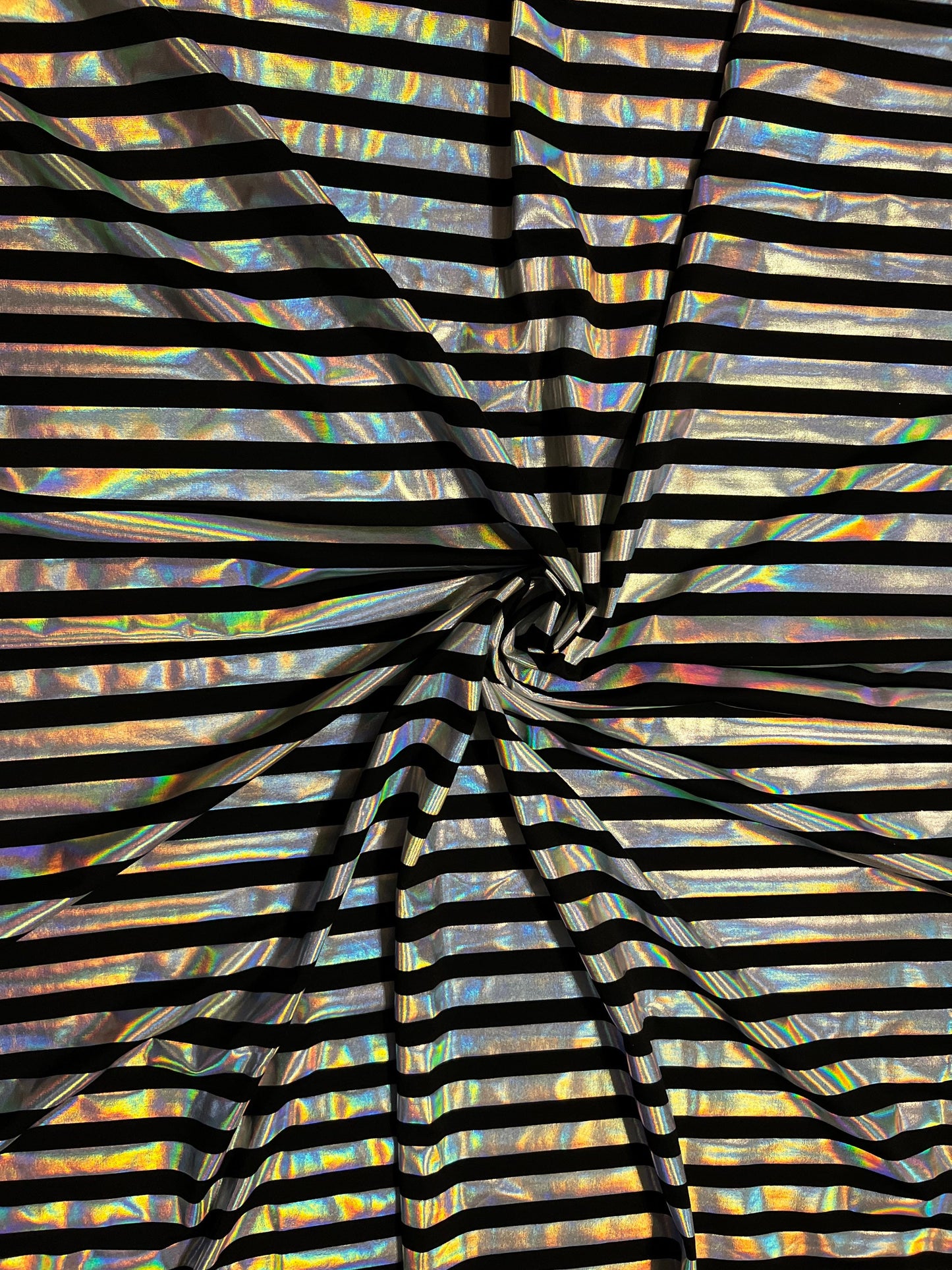 Metallic stripe design black/iridescent silver poly spandex 2-way stretch with lacer foil 58/60” Sold by the YD. Ships Worldwide from L.A CA