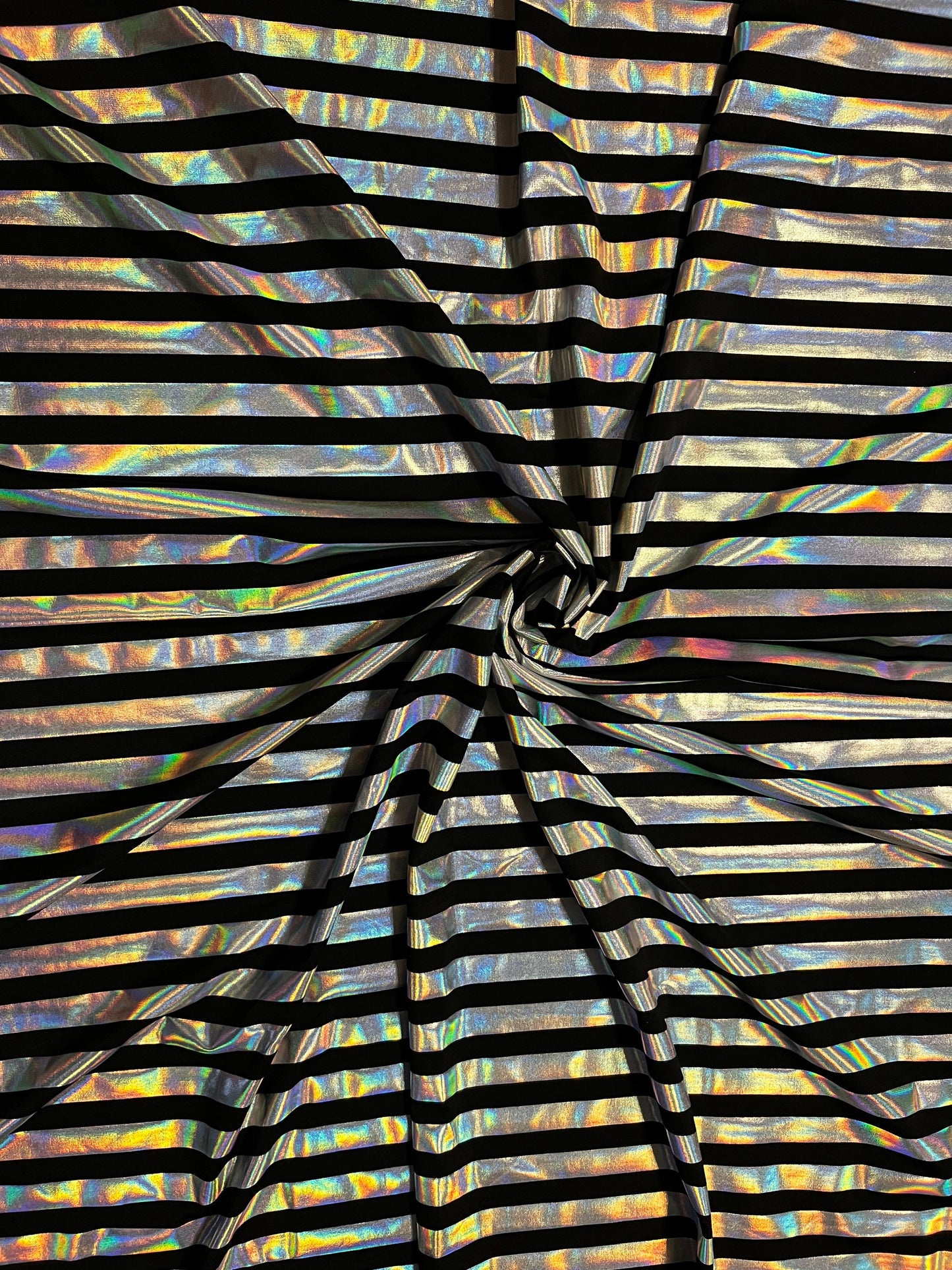 Metallic stripe design black/iridescent silver poly spandex 2-way stretch with lacer foil 58/60” Sold by the YD. Ships Worldwide from L.A CA