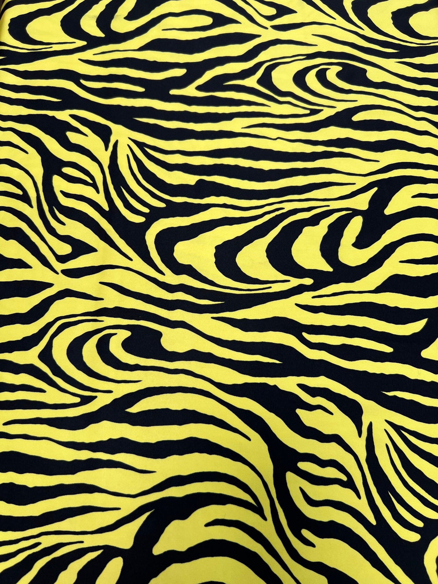 Exotic Zebra design yellow/black print on great quality of poly spandex 4-way stretch 58/60” Sold by the YD. Ships Worldwide from L.A CA