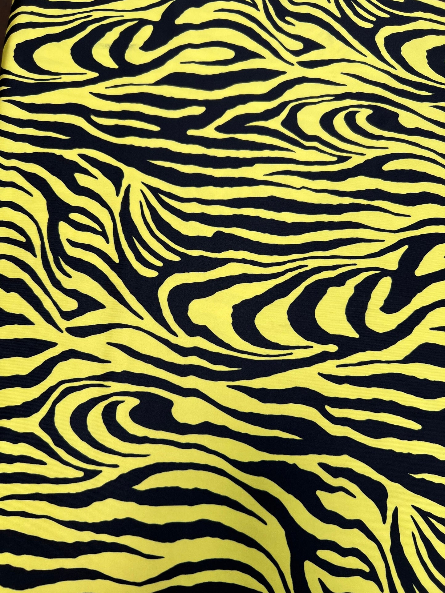 Exotic Zebra design yellow/black print on great quality of poly spandex 4-way stretch 58/60” Sold by the YD. Ships Worldwide from L.A CA