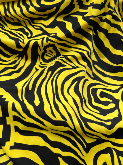 Exotic zebra design black/yellow print on nylon spandex 4way stretch 58/60” Sold by the YD. Ships worldwide from Los Angeles California USA.