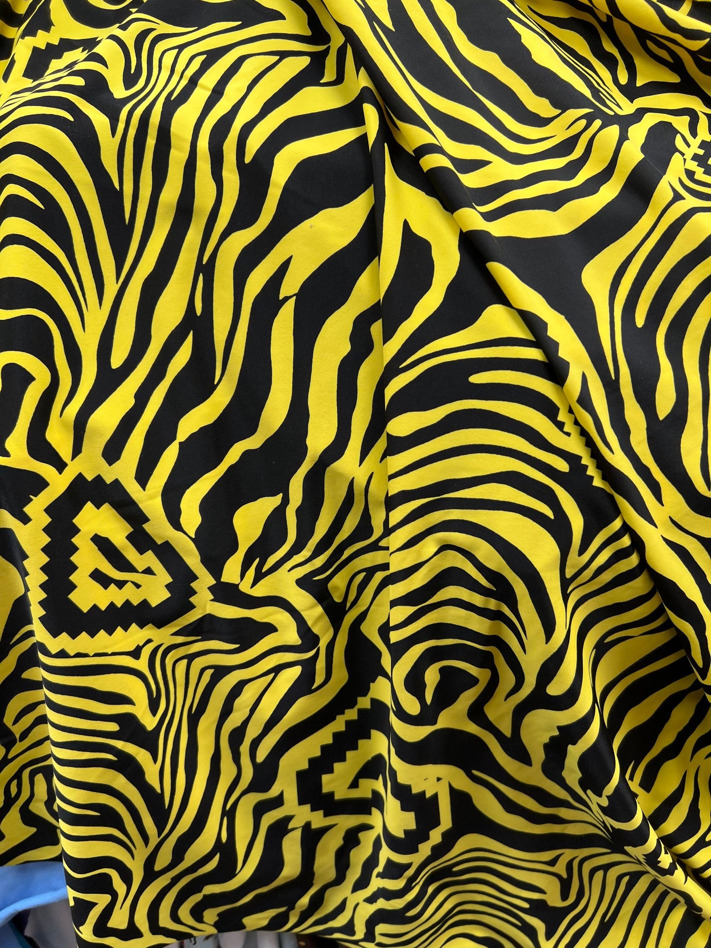 Exotic zebra design black/yellow print on nylon spandex 4way stretch 58/60” Sold by the YD. Ships worldwide from Los Angeles California USA.