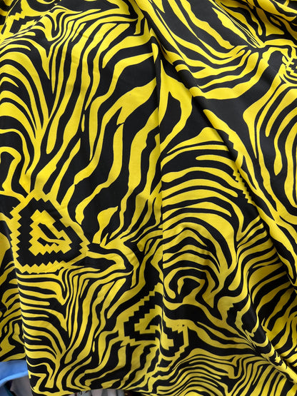 Exotic zebra design black/yellow print on nylon spandex 4way stretch 58/60” Sold by the YD. Ships worldwide from Los Angeles California USA.