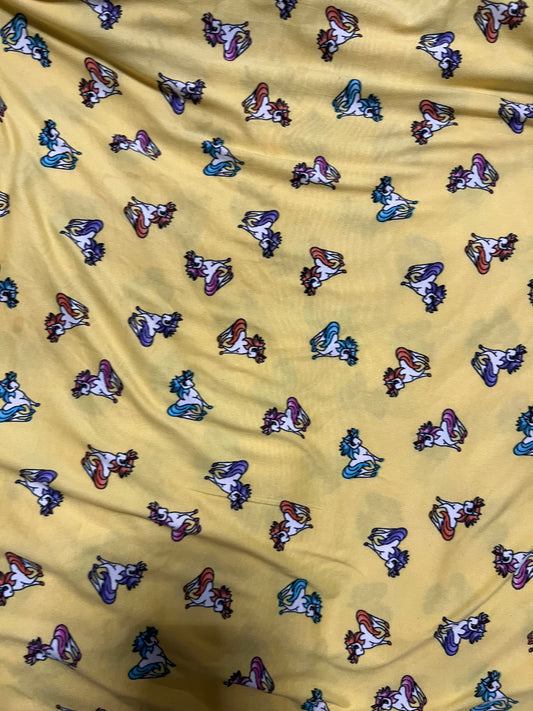 Little Pony design print on light weight poly spandex 4-way stretch yellow/multicolor 58/60” Sold by the YD.
