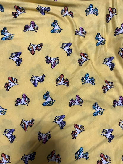 Little Pony design print on light weight poly spandex 4-way stretch yellow/multicolor 58/60” Sold by the YD.