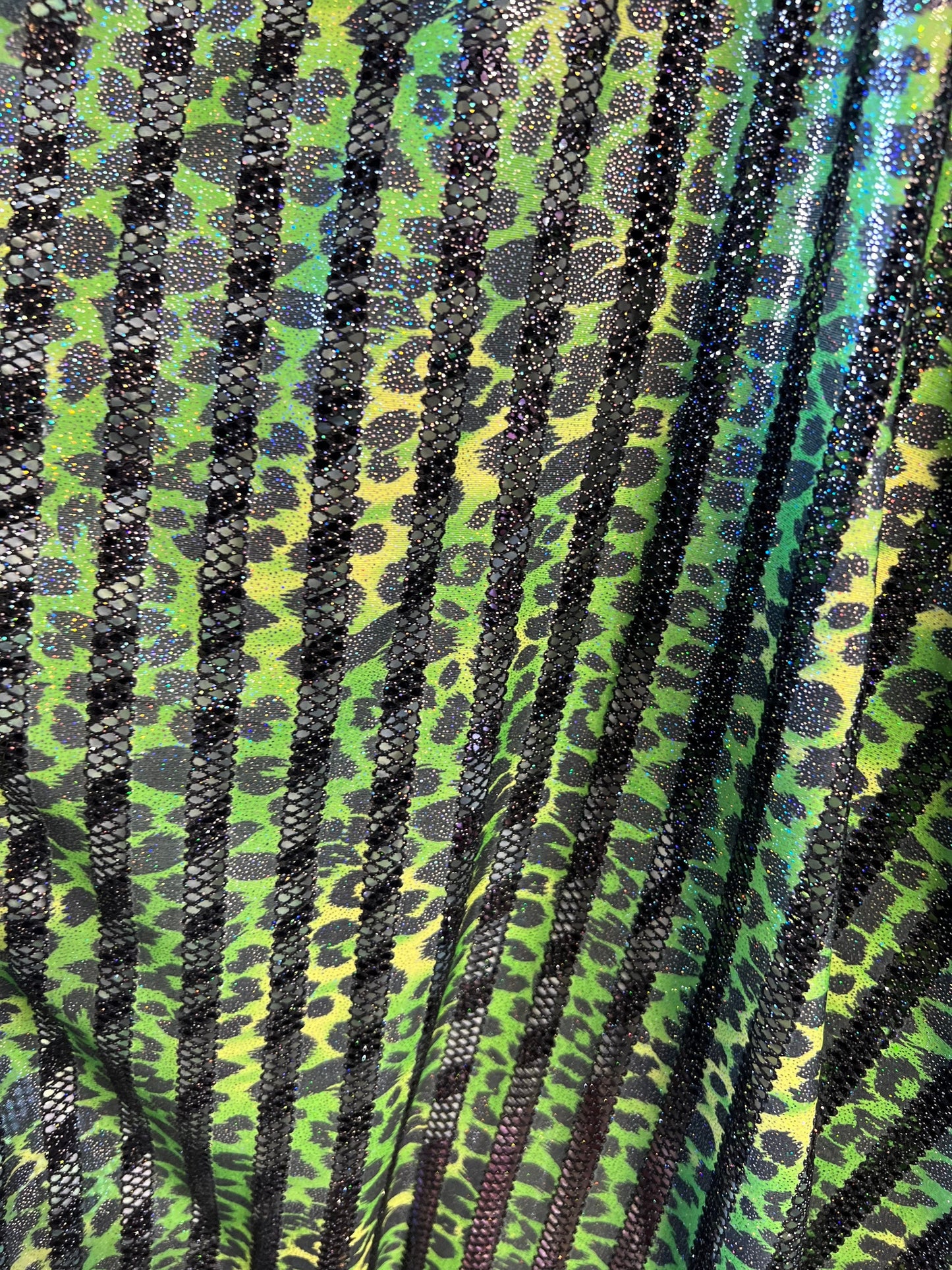Exotic Leopard design print on nylon fish net with metallic glitter 4-way stretch 58/60” Sold by the YD. Ships Worldwide from Los Angeles CA