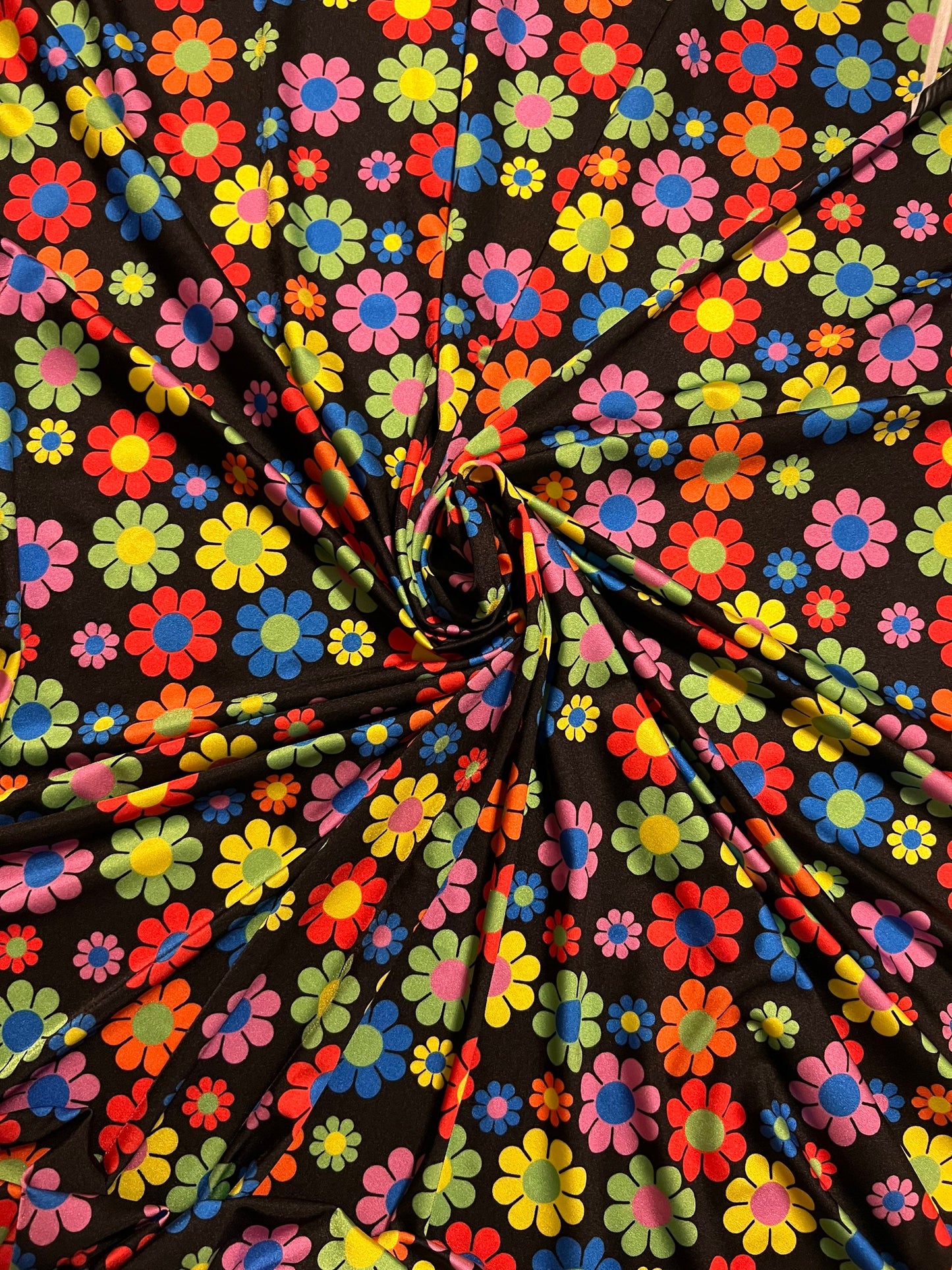 New daisy flower design Black/Multicolor print on great quality of nylon spandex 4-way stretch 58/60” Sold by the YD.