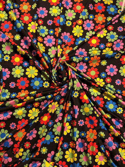 New daisy flower design Black/Multicolor print on great quality of nylon spandex 4-way stretch 58/60” Sold by the YD.