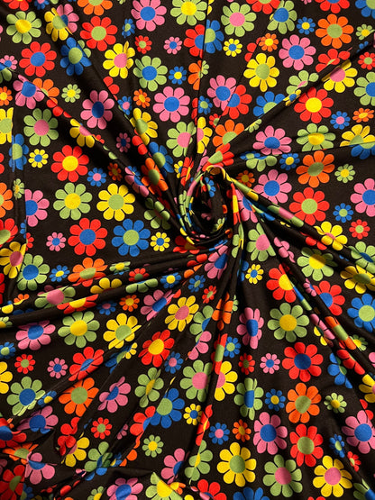 New daisy flower design Black/Multicolor print on great quality of nylon spandex 4-way stretch 58/60” Sold by the YD.