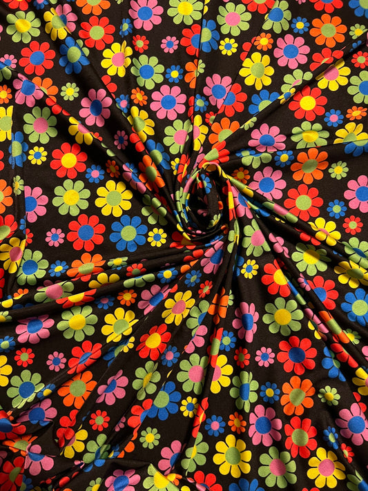 New daisy flower design Black/Multicolor print on great quality of nylon spandex 4-way stretch 58/60” Sold by the YD.