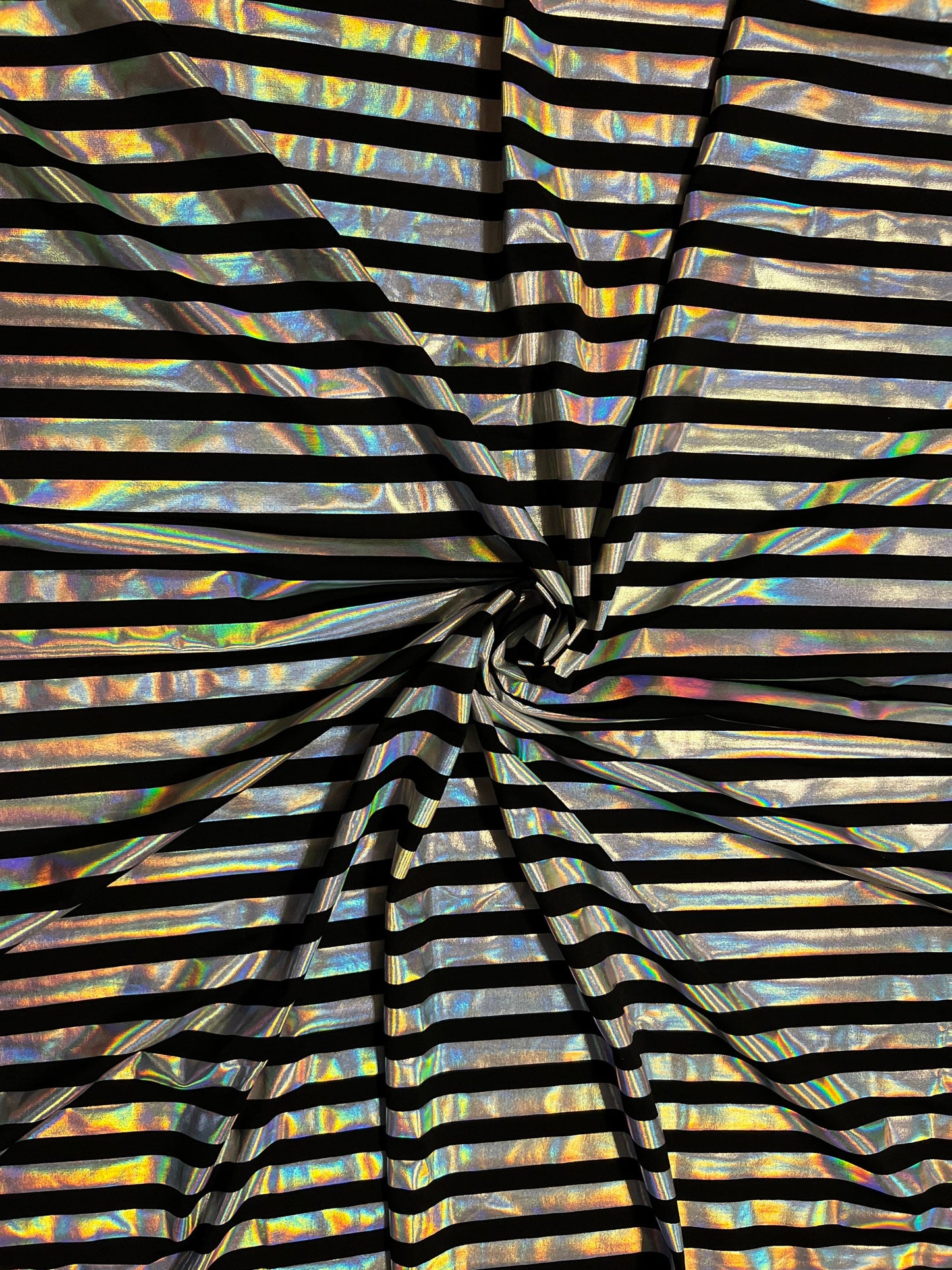 Metallic stripe design black/iridescent silver poly spandex 2-way stretch with lacer foil 58/60” Sold by the YD. Ships Worldwide from L.A CA