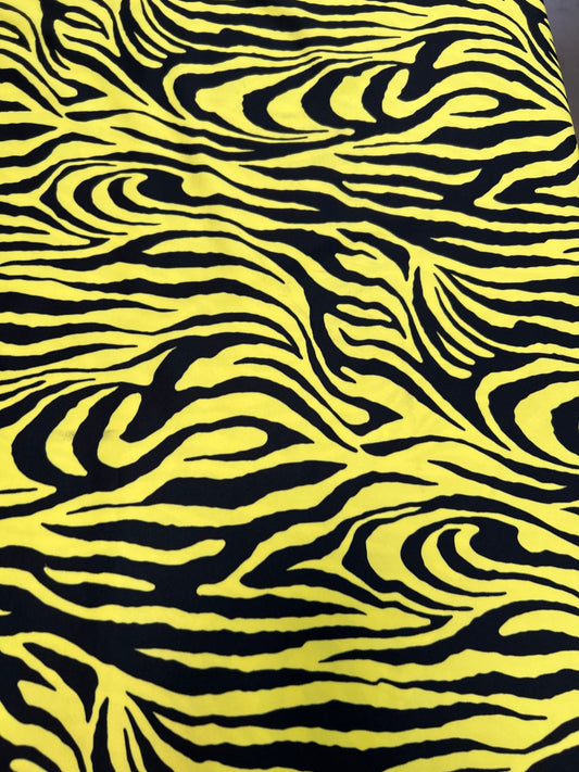 Exotic Zebra design yellow/black print on great quality of poly spandex 4-way stretch 58/60” Sold by the YD. Ships Worldwide from L.A CA