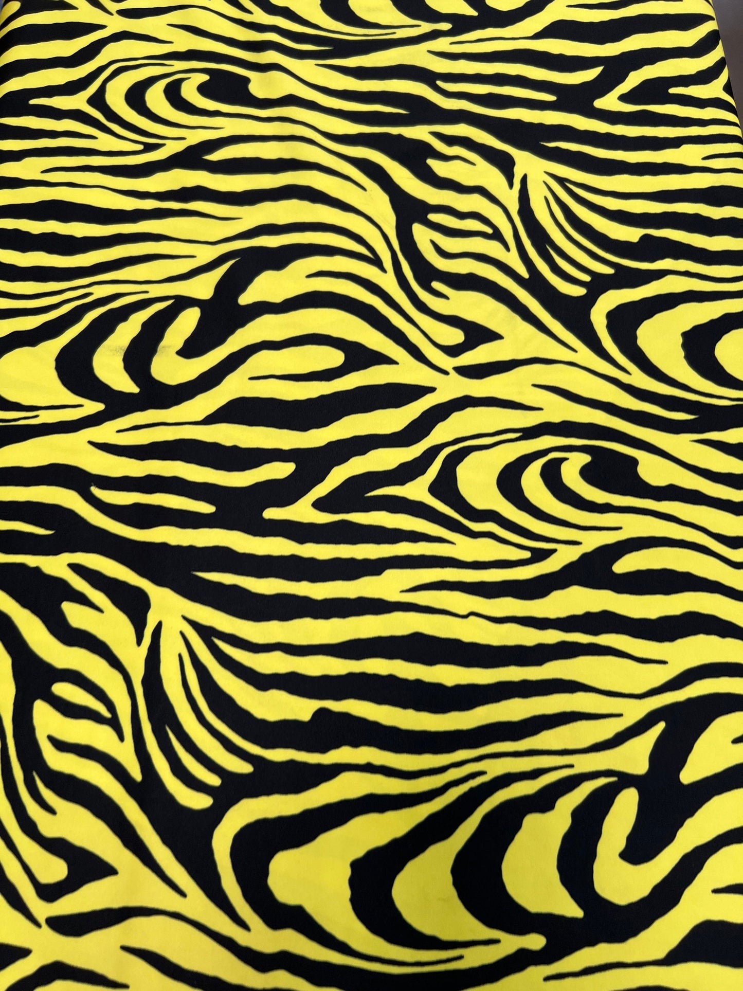 Exotic Zebra design yellow/black print on great quality of poly spandex 4-way stretch 58/60” Sold by the YD. Ships Worldwide from L.A CA
