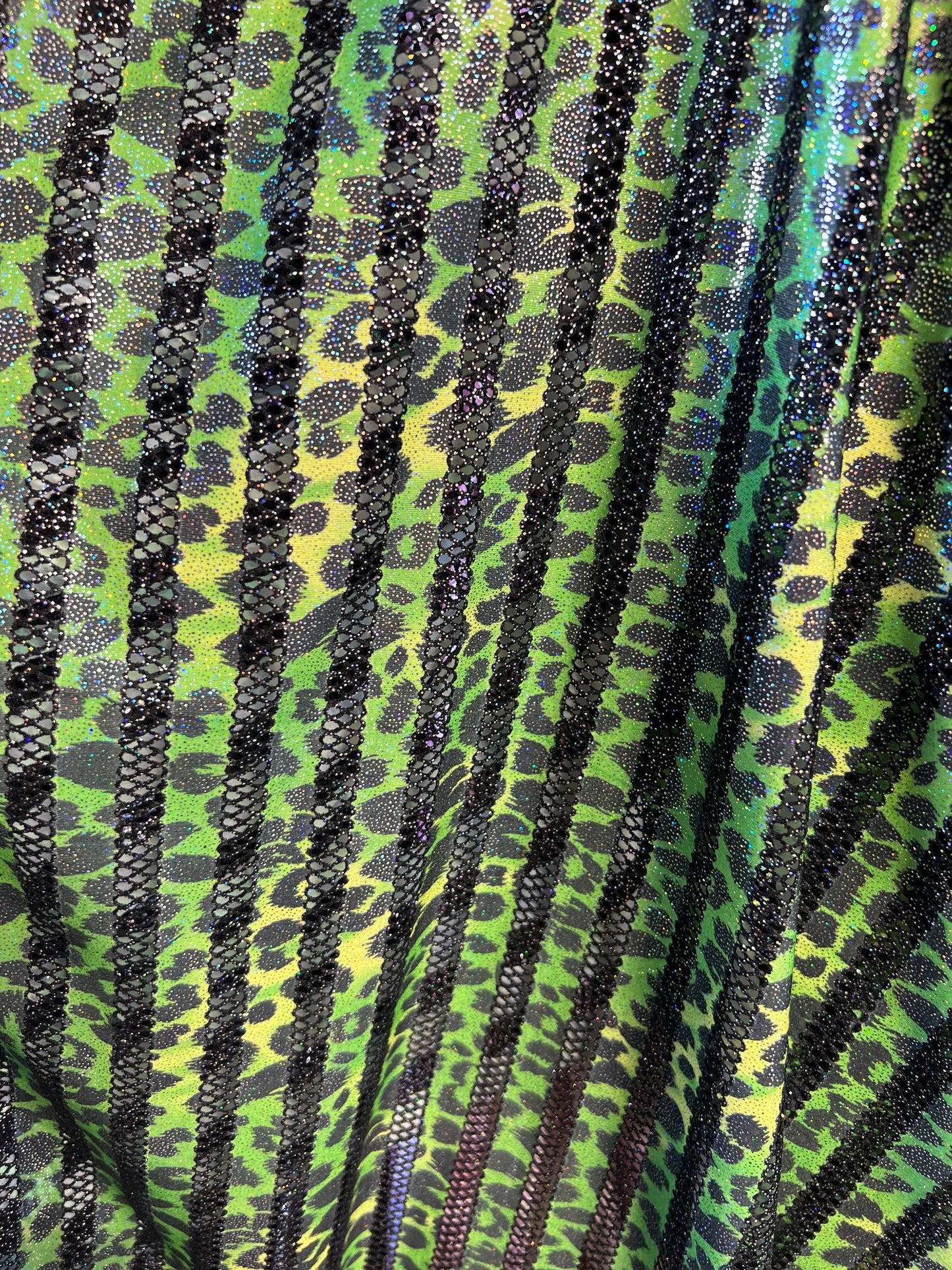 Exotic Leopard design print on nylon fish net with metallic glitter 4-way stretch 58/60” Sold by the YD. Ships Worldwide from Los Angeles CA