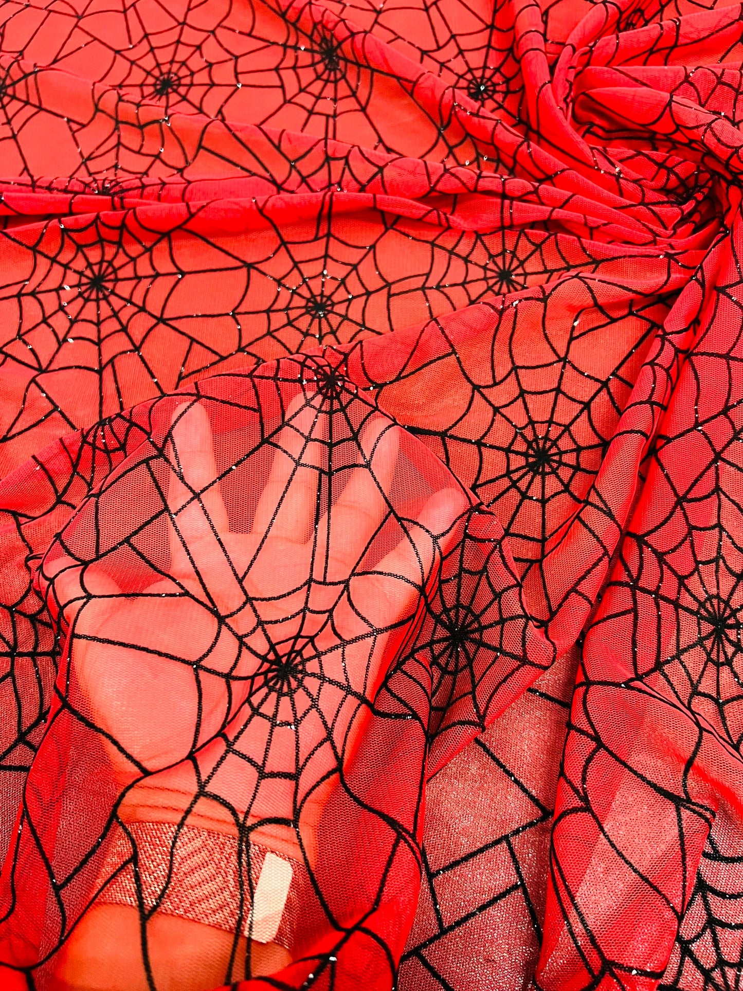 Spiderweb design red/black flocking stretch mesh 2-way stretch 58/60” Sold by the YD. Ships Worldwide from Los Ángeles California USA