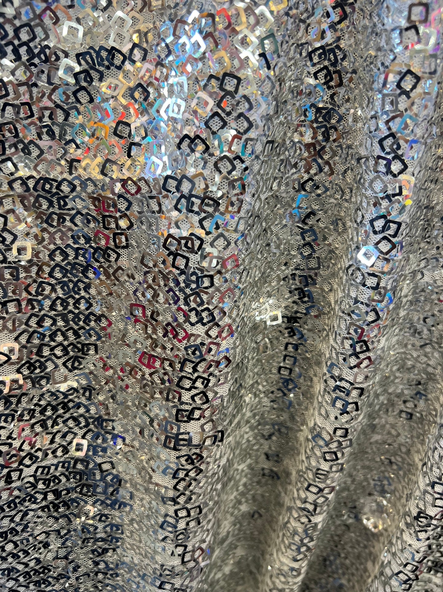 Geometric sequins design embroidered on stretch mesh 2-way 58/60” Sold by the YD. Ships Worldwide from Los Angeles California USA.