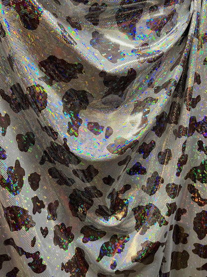 Cow design w/silver/Black & w/silver/brown on shattered glass New metallic hologram nylon spandex 4-way stretch 58/60” Sold by the YD.