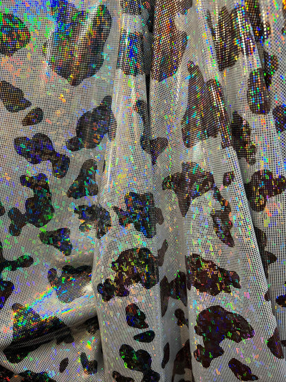 Cow design w/silver/Black & w/silver/brown on shattered glass New metallic hologram nylon spandex 4-way stretch 58/60” Sold by the YD.