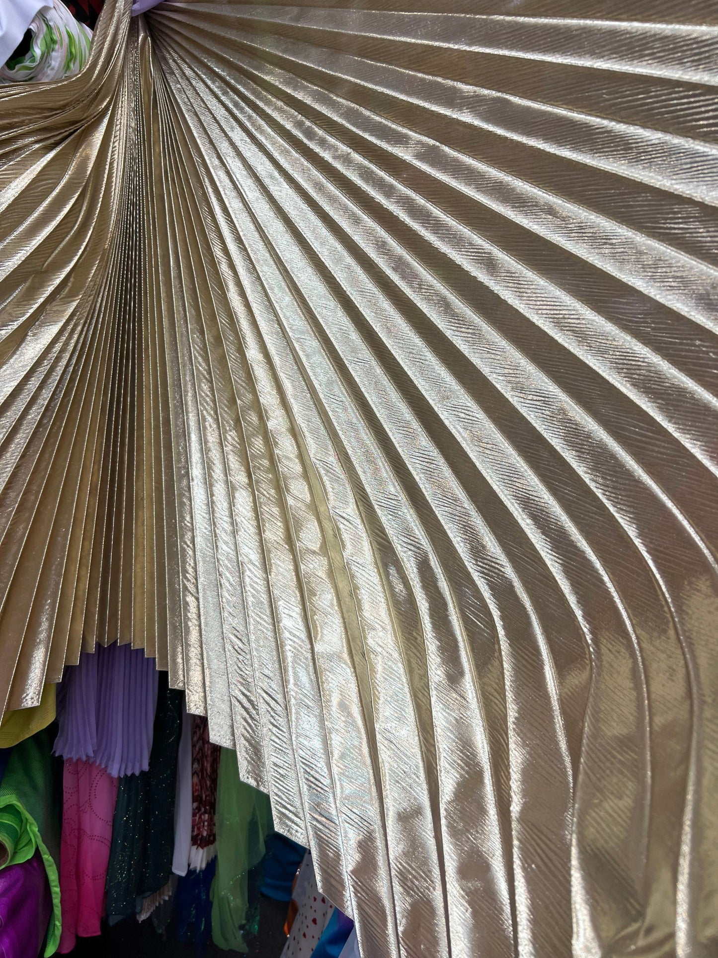 Sunburst pleated metallic lame non stretch 108” length by 45” width Sold by the PC. Ships worldwide from Los Angeles California USA