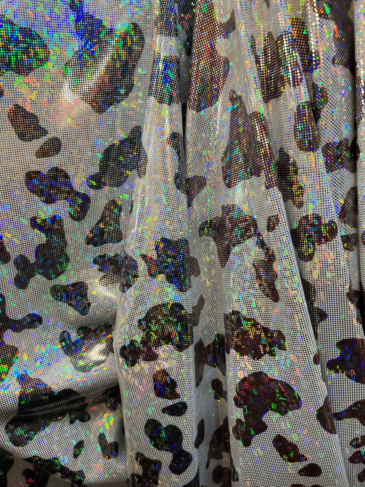 Cow design w/silver/Black & w/silver/brown on shattered glass New metallic hologram nylon spandex 4-way stretch 58/60” Sold by the YD.