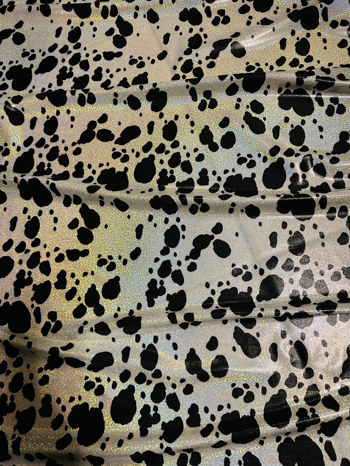 Dalmatian design on hologram foggy foil metallic nylon spandex 4-way stretch 58/60” Sold by the YD. Ships worldwide from L.A