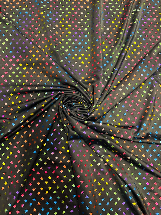 Stars multicolor design black/rainbow print on best quality of nylon spandex 4-way stretch 58/60” Sold by the YD.