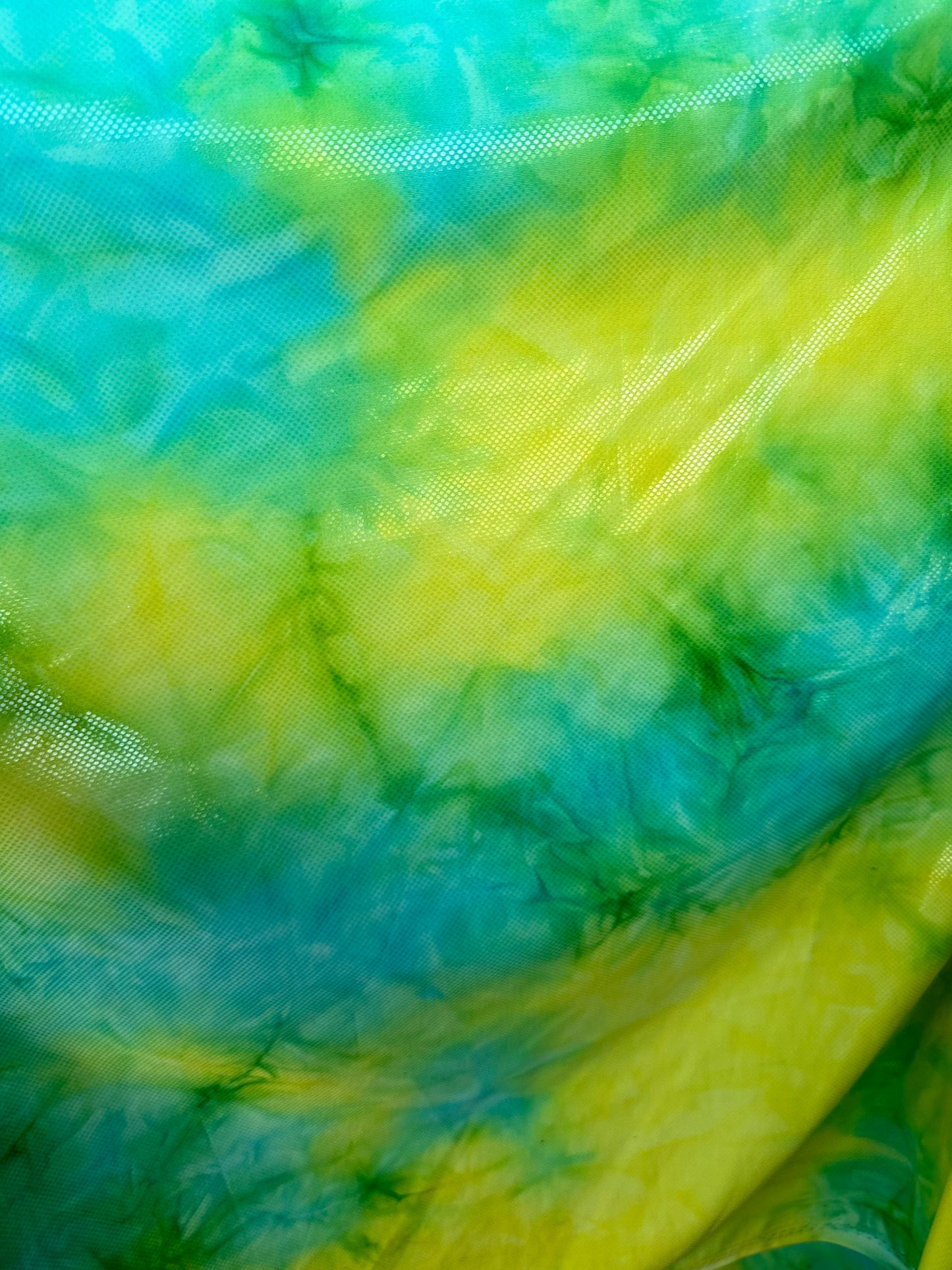 Tie dye design aqua/yellow metallic nylon spandex 4-way stretch 58/60” Sold by the YD. Ships worldwide from Los Angeles California USA