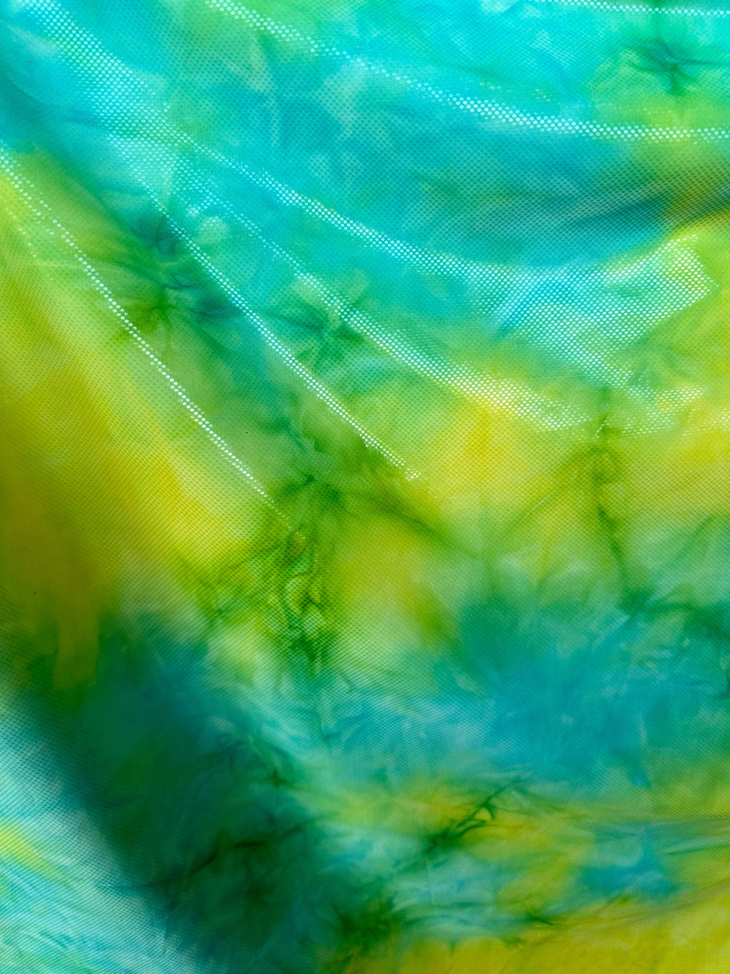 Tie dye design aqua/yellow metallic nylon spandex 4-way stretch 58/60” Sold by the YD. Ships worldwide from Los Angeles California USA