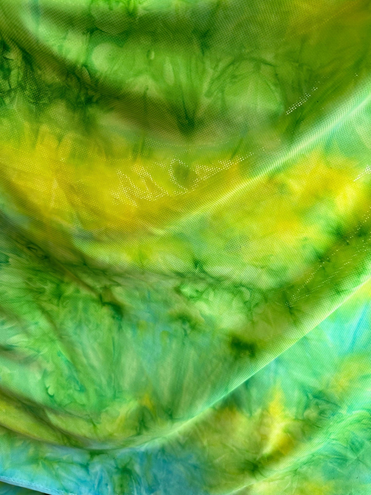 Tie dye design aqua/yellow metallic nylon spandex 4-way stretch 58/60” Sold by the YD. Ships worldwide from Los Angeles California USA