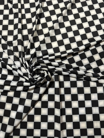 Checkers design 1” size white/black print on great quality of nylon spandex 4-way stretch 58/60” Sold by the YD.