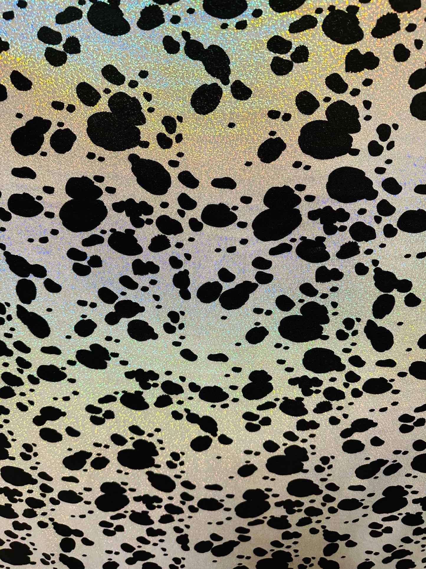 Dalmatian design on hologram foggy foil metallic nylon spandex 4-way stretch 58/60” Sold by the YD. Ships worldwide from L.A
