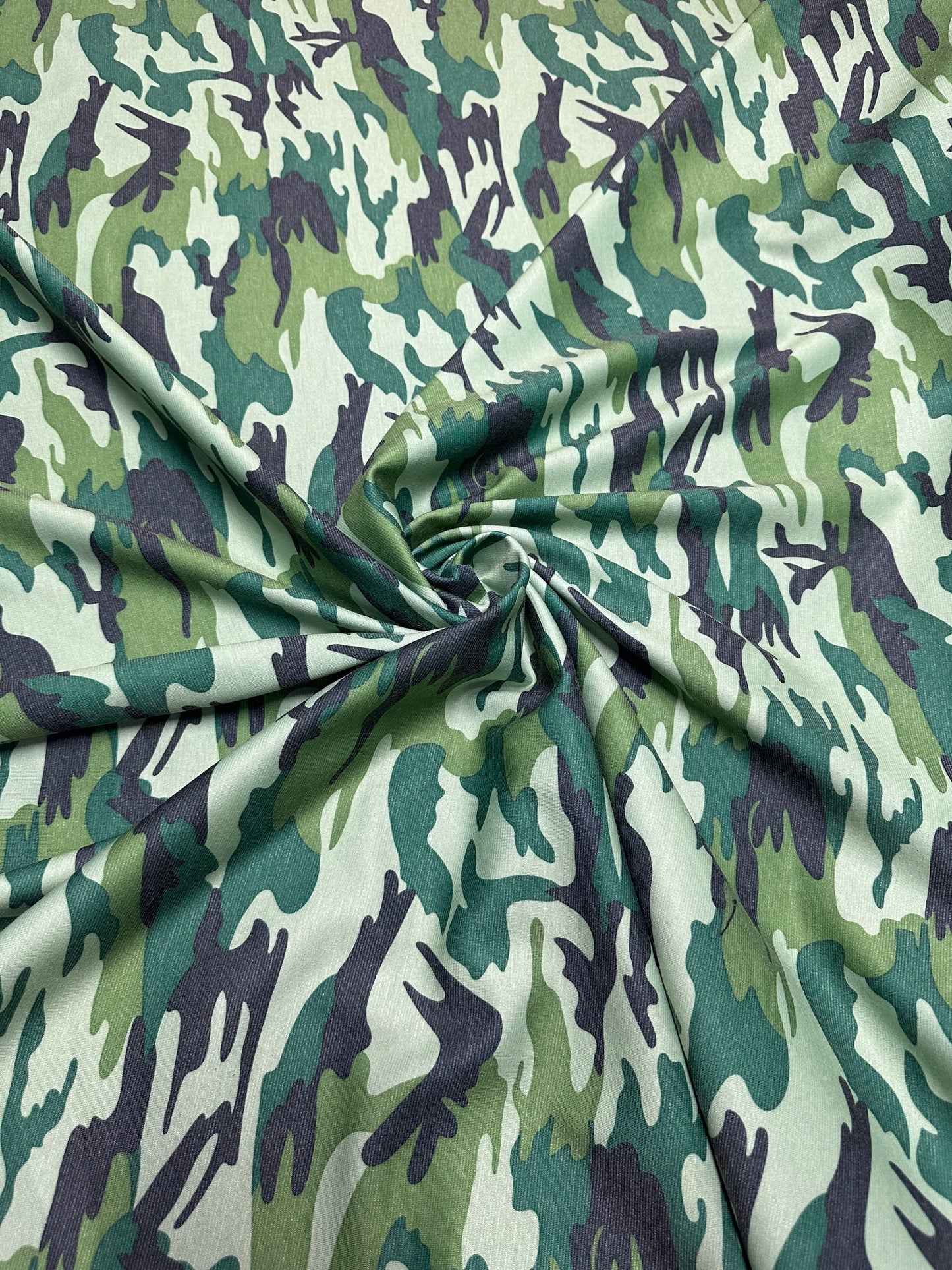Camouflage design army green print on Poly spandex ponte de Roma 2-way stretch 58/60” Sold by the YD. Ships worldwide from Los Angeles Calif