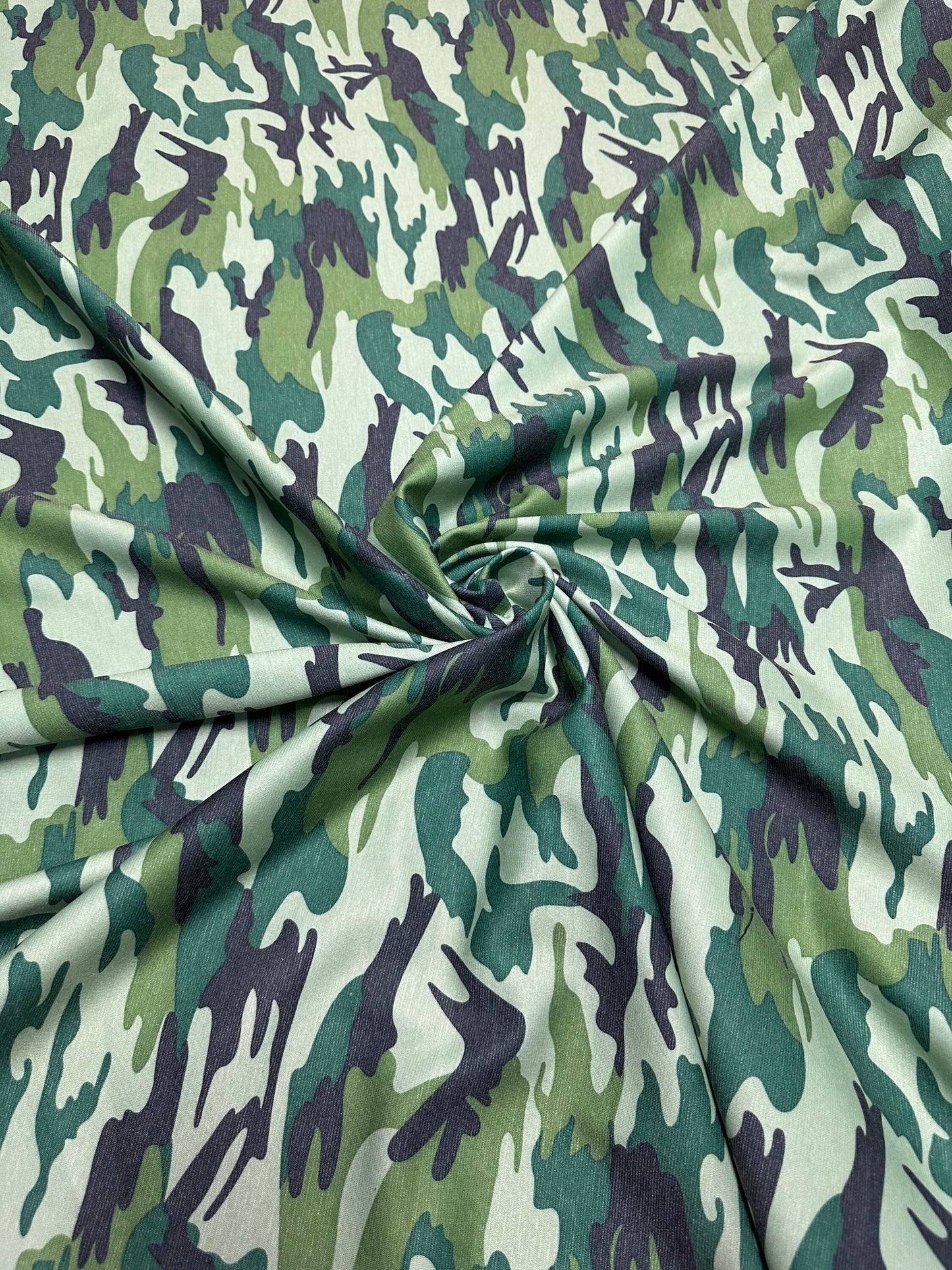 Camouflage design army green print on Poly spandex ponte de Roma 2-way stretch 58/60” Sold by the YD. Ships worldwide from Los Angeles Calif
