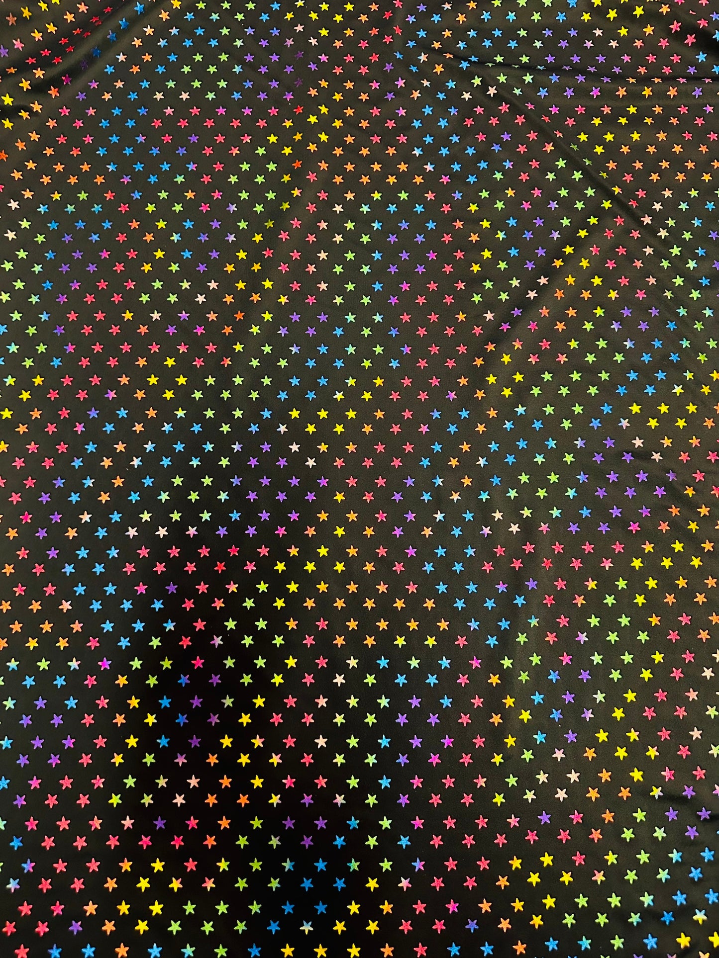 Stars multicolor design black/rainbow print on best quality of nylon spandex 4-way stretch 58/60” Sold by the YD.