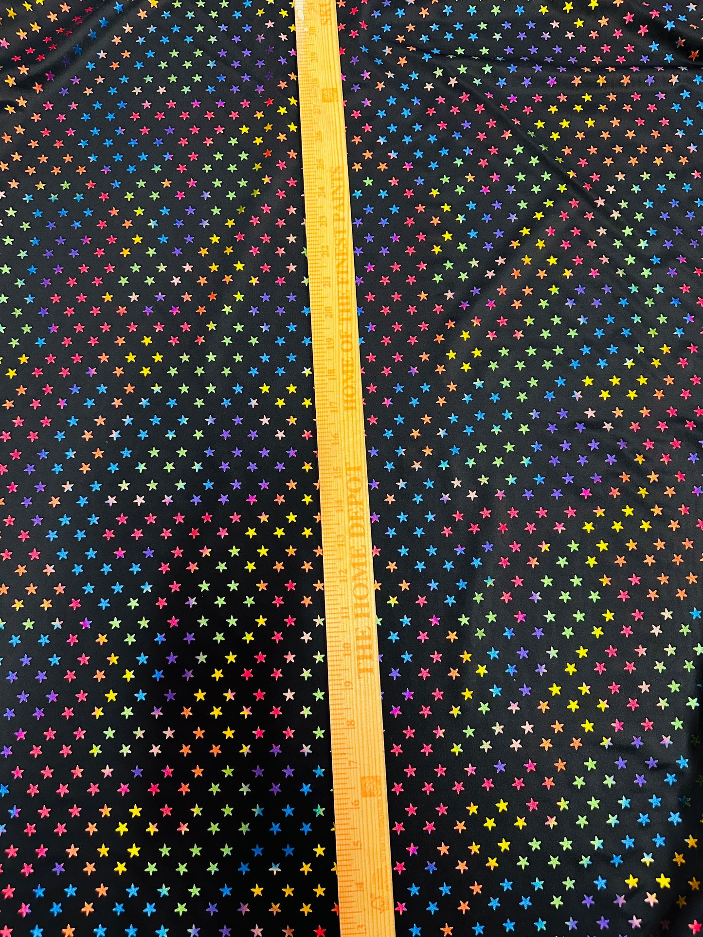 Stars multicolor design black/rainbow print on best quality of nylon spandex 4-way stretch 58/60” Sold by the YD.