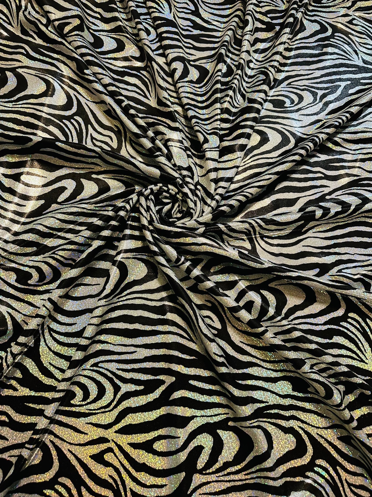 Wild Zebra design hologram metallic nylon spandex with iridescent foggy foil 58/60” 4-way stretch.