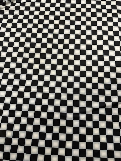 Checkers design 1” size white/black print on great quality of nylon spandex 4-way stretch 58/60” Sold by the YD.