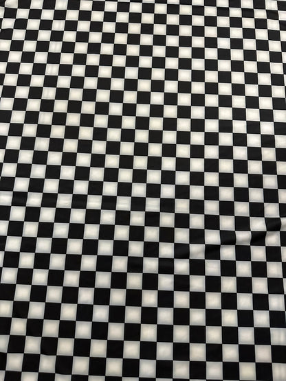 Checkers design 1” size white/black print on great quality of nylon spandex 4-way stretch 58/60” Sold by the YD.