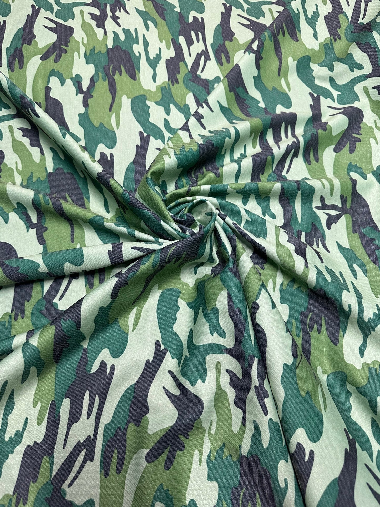 Camouflage design army green print on Poly spandex ponte de Roma 2-way stretch 58/60” Sold by the YD. Ships worldwide from Los Angeles Calif