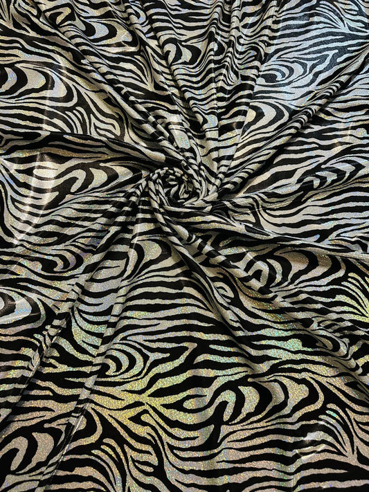 Wild Zebra design hologram metallic nylon spandex with iridescent foggy foil 58/60” 4-way stretch.