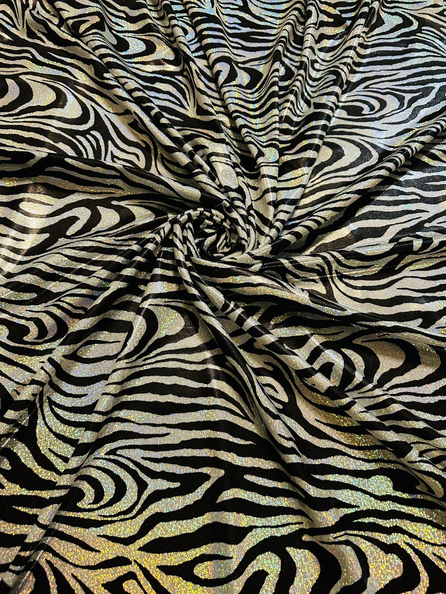 Wild Zebra design hologram metallic nylon spandex with iridescent foggy foil 58/60” 4-way stretch.