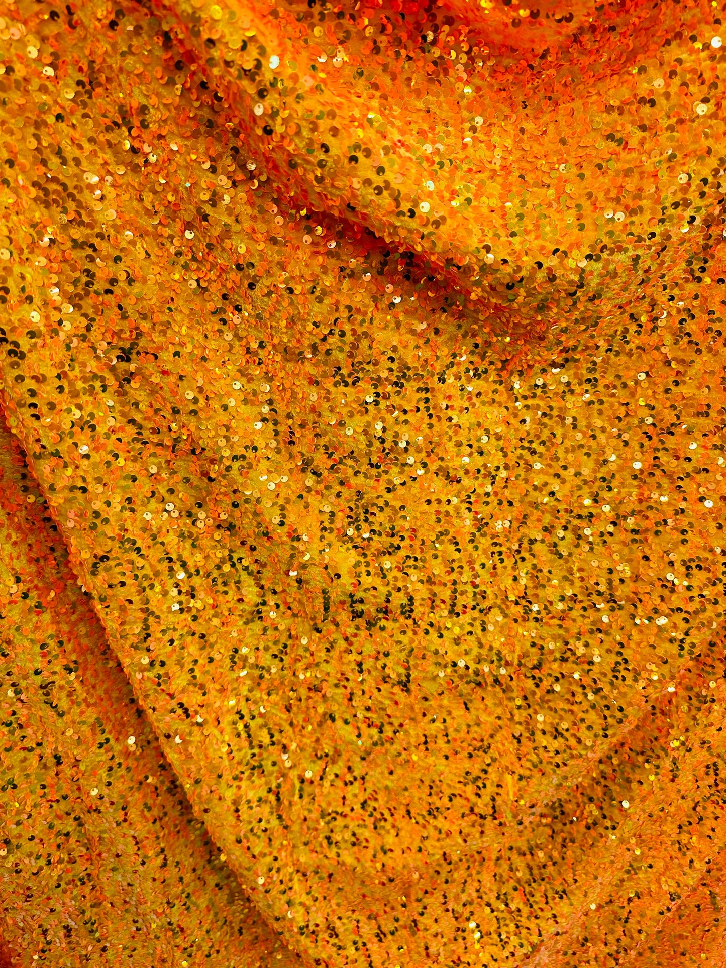Luxury Iridescent sequins neon orange embroidered on stretch velvet 4-way stretch 58/60” Sold by the YD.