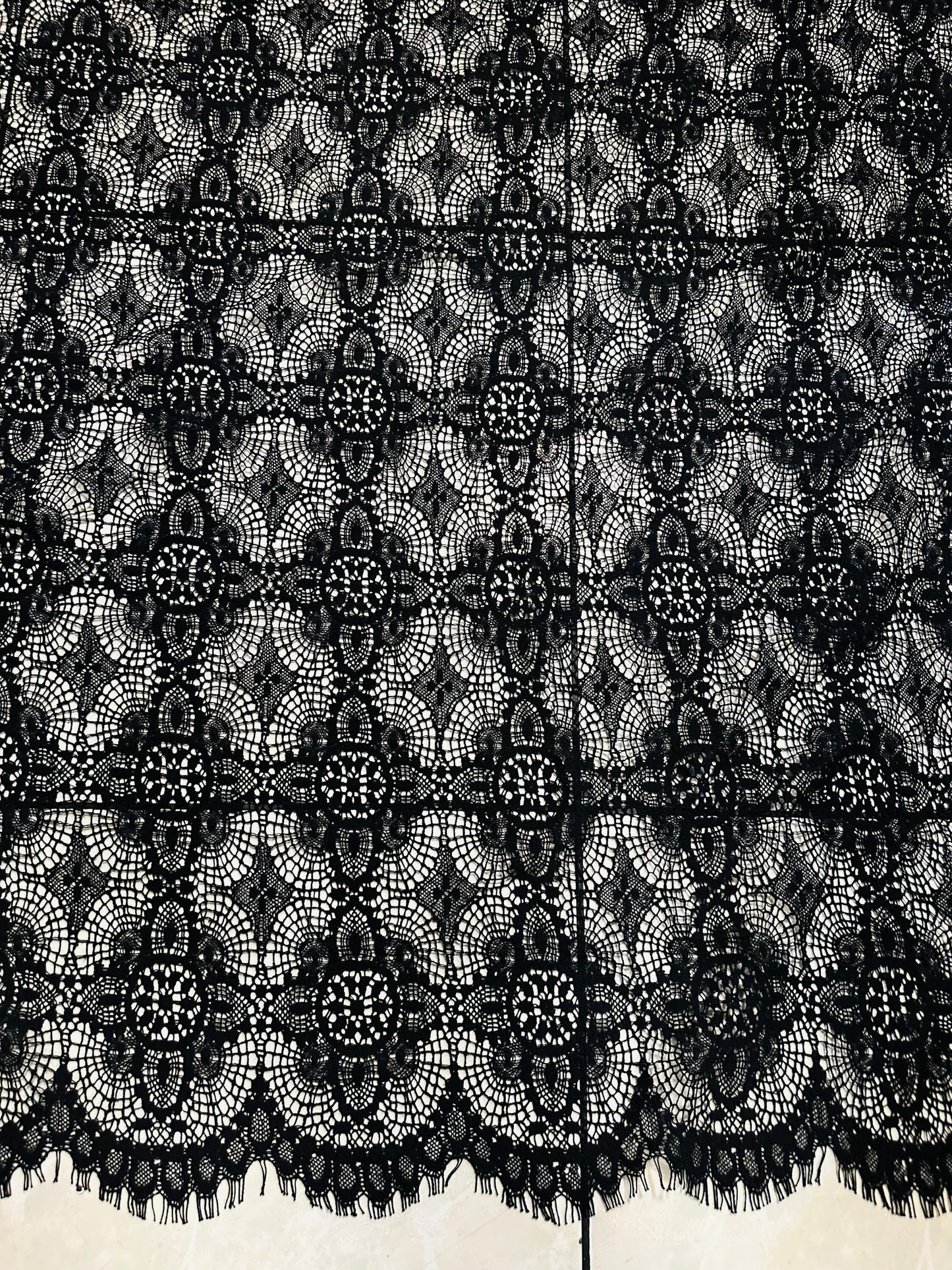French chantilly lace, Black 36” wide, allover rose abstract design, 2 scallop edges with eyelash fringe. This is an elegant-looking lace.